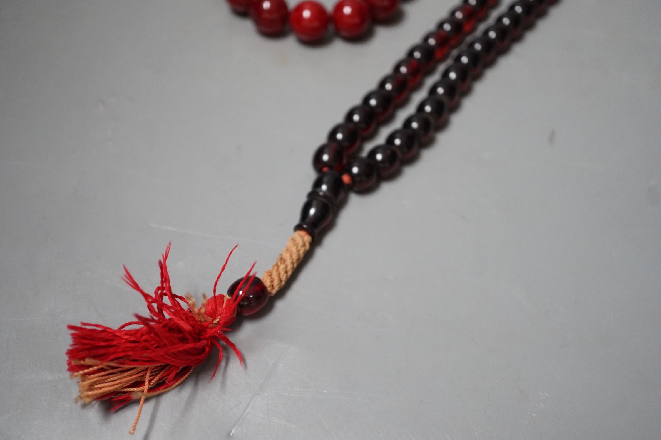 Two simulated Cherry Amber beads